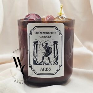 Ares Intention Candle with red jasper, tiger's eye, sword charm, and wax skull
